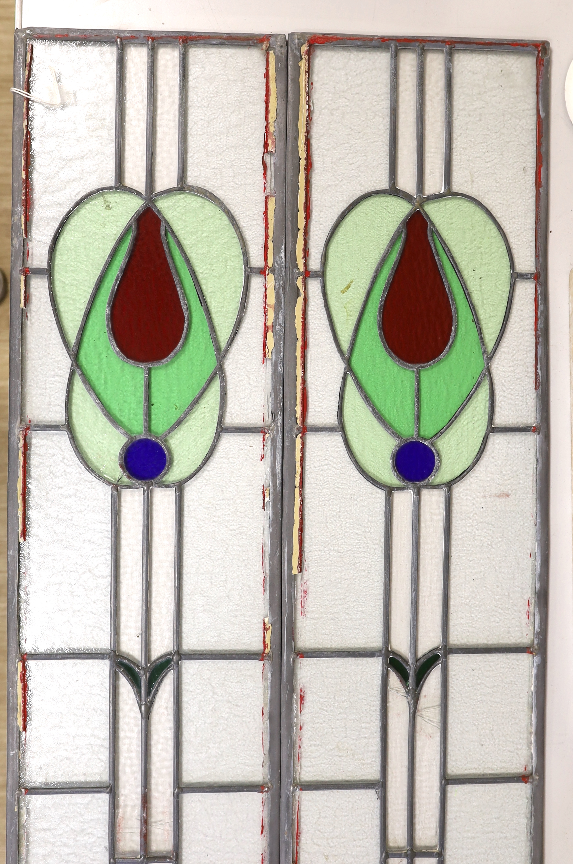 A pair of stained glass leaded panels, 98cm high x 25.5cm wide